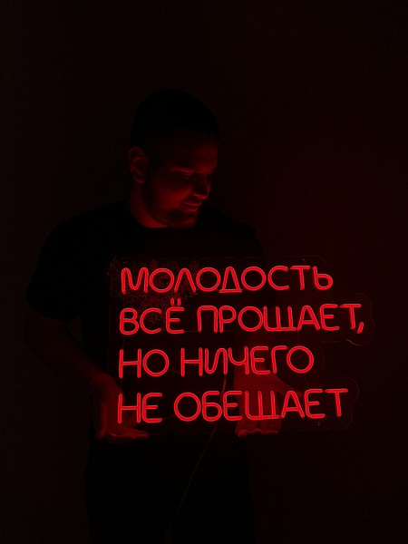 Неоновая вывеска "Молодость все прощает, но ничего не обещает"